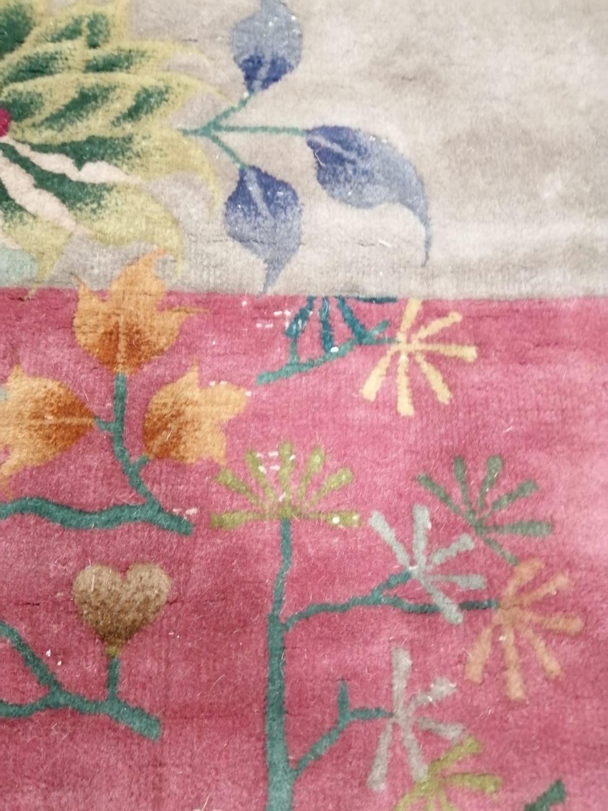 A large early 20th century Chinese cerise ground floral ground carpet, 530 x 358cm